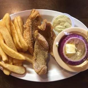 Three piece fried catfish with steak fries, cole slaw, slice of red onion, and tartar sauce.
