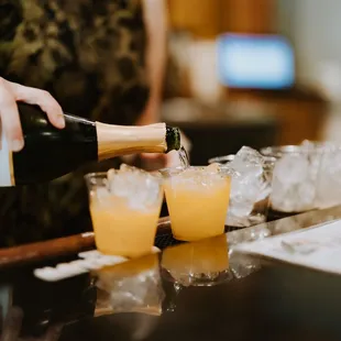 a woman pouring a glass of champagne