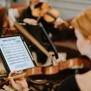 a woman playing the violin