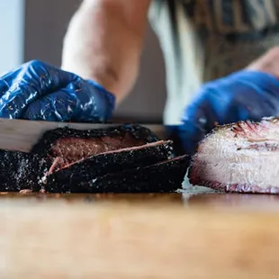 a man cutting a piece of meat