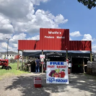 a farmer's market with a tractor in the background