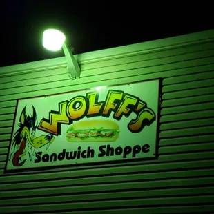 a neon sign for a sandwich shop