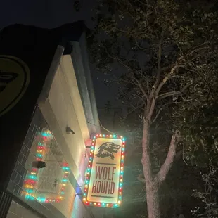 a neon sign in front of a building