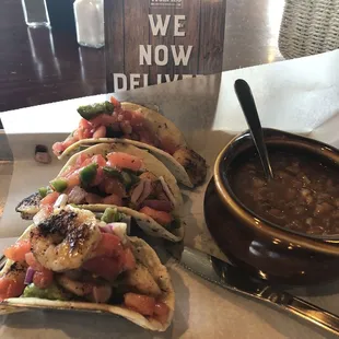 Blackened shrimp tacos ( $14) , including one side. I chose baked beans.. tasty