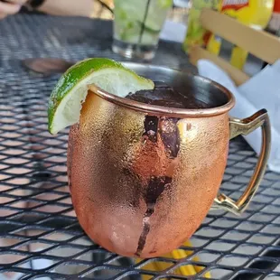 a copper mug with a garnish of lime