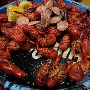 a bowl of crawfish and corn