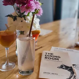 a glass of wine and a book on a table