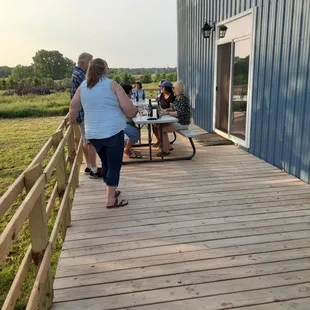 a group of people sitting at picnic tables