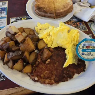 Corned beef hash, eggs, fried potatoes and toast