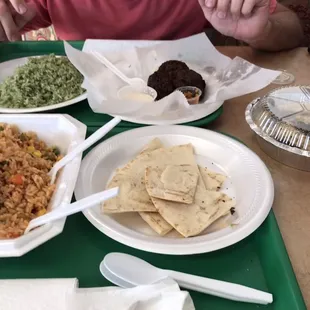 Green rice, burned falafel, watery tahini, and spoiled baba ganoush, another rice dish, and pita