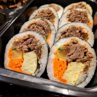 C1. Bulgogi, Kimbap &amp; Buchimgae. Close-up of gimbap. $9.99.