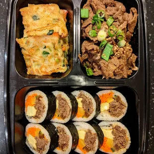 C1. Bulgogi, Kimbap &amp; Buchimgae. Overhead shot. $9.99.