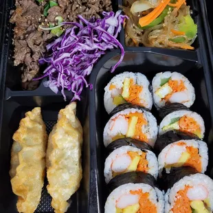  tray of sushi and vegetables