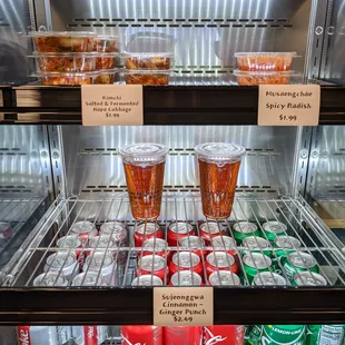 Inside. Self-serve drink fridge, also with kimchi, spicy radish, and Korean cinnamon ginger punch.