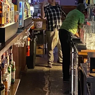 two men standing at the bar