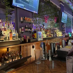 a bar with a lot of bottles of alcohol