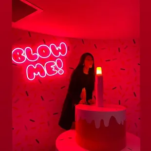 a woman standing in front of a birthday cake