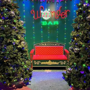 a red bench and christmas trees