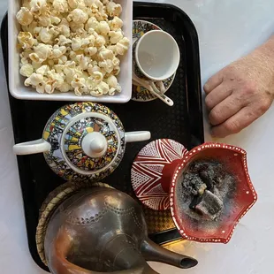 Coffee service includes incense and popcorn.