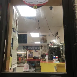 a store window with a santa sign in the window
