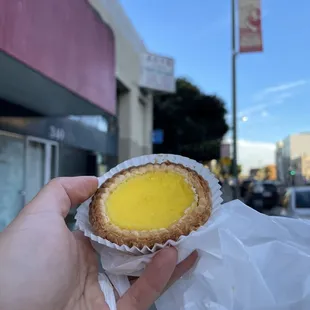 a hand holding a pastry