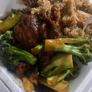 a plate of food with rice and broccoli