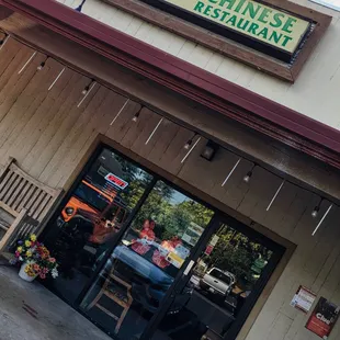 The exterior of the restaurant at a small strip mall.