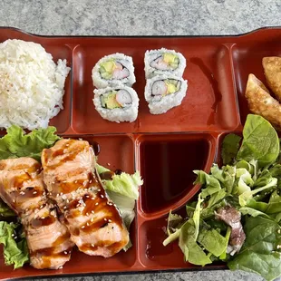 a bento tray with a variety of food items