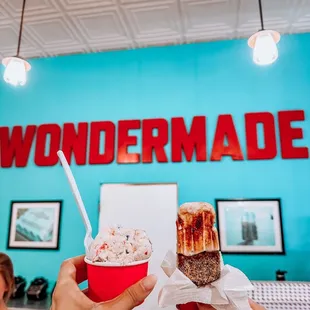 two people holding up ice cream cones
