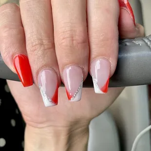 Coffin shaped, red and white French tips with a touch of glitter