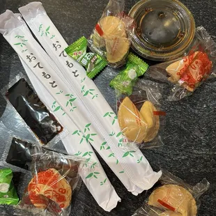 Take out utensils, candies, dumpling sauce, and Fortune Cookies