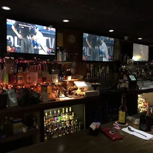 a bar with several televisions