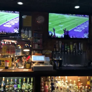 a bar with multiple televisions