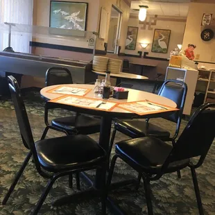 a dining room with a table and chairs