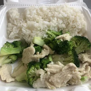 Steamed chicken and broccoli with steamed rice.