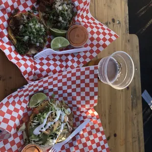 two plates of tacos and a drink