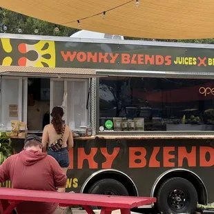 a food truck with people eating