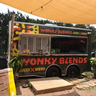 a food truck parked under a shade