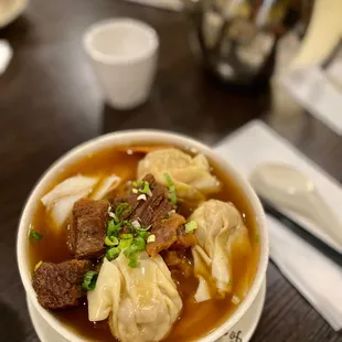 Beef brisket and wonton wide rice noodle soup