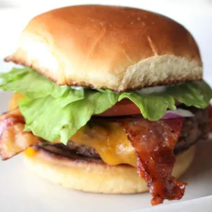 a hamburger with bacon and lettuce