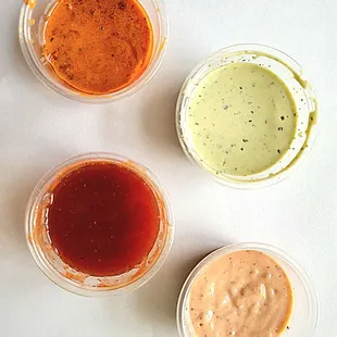 Top left - Zard sauce. Top right - Somi sauce Bottom left - Mumbo sauce.  Bottom right - Comeback sauce.