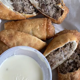 Signature Cheese Steak Egg Rolls with Queso Dip.