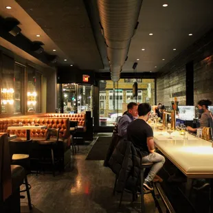 people sitting at a bar in a restaurant