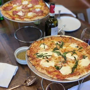 two pizzas on a table