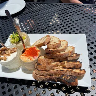 a plate of bread and dips