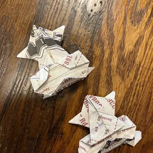 a pair of folded paper airplanes