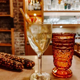 a glass of gin and a goblet