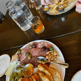 Charcuterie board, and Chicken Sandwich with Parmesan Garlic Fries.