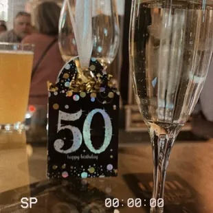 a glass of champagne and a gift