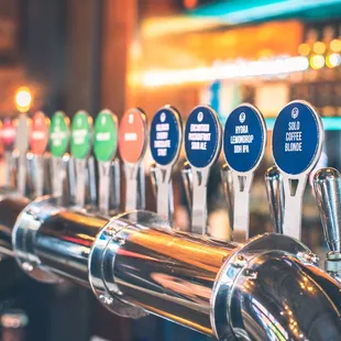 a row of beer taps